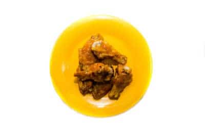 hot wings on a yellow plate