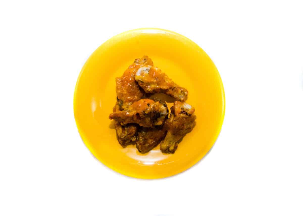 hot wings on a yellow plate