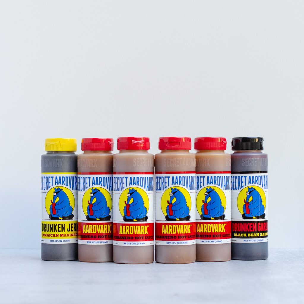 Bottles of Secret Aardvark sauces (Drunken Jerk, Aardvark Habanero, and Drunken Garlic)