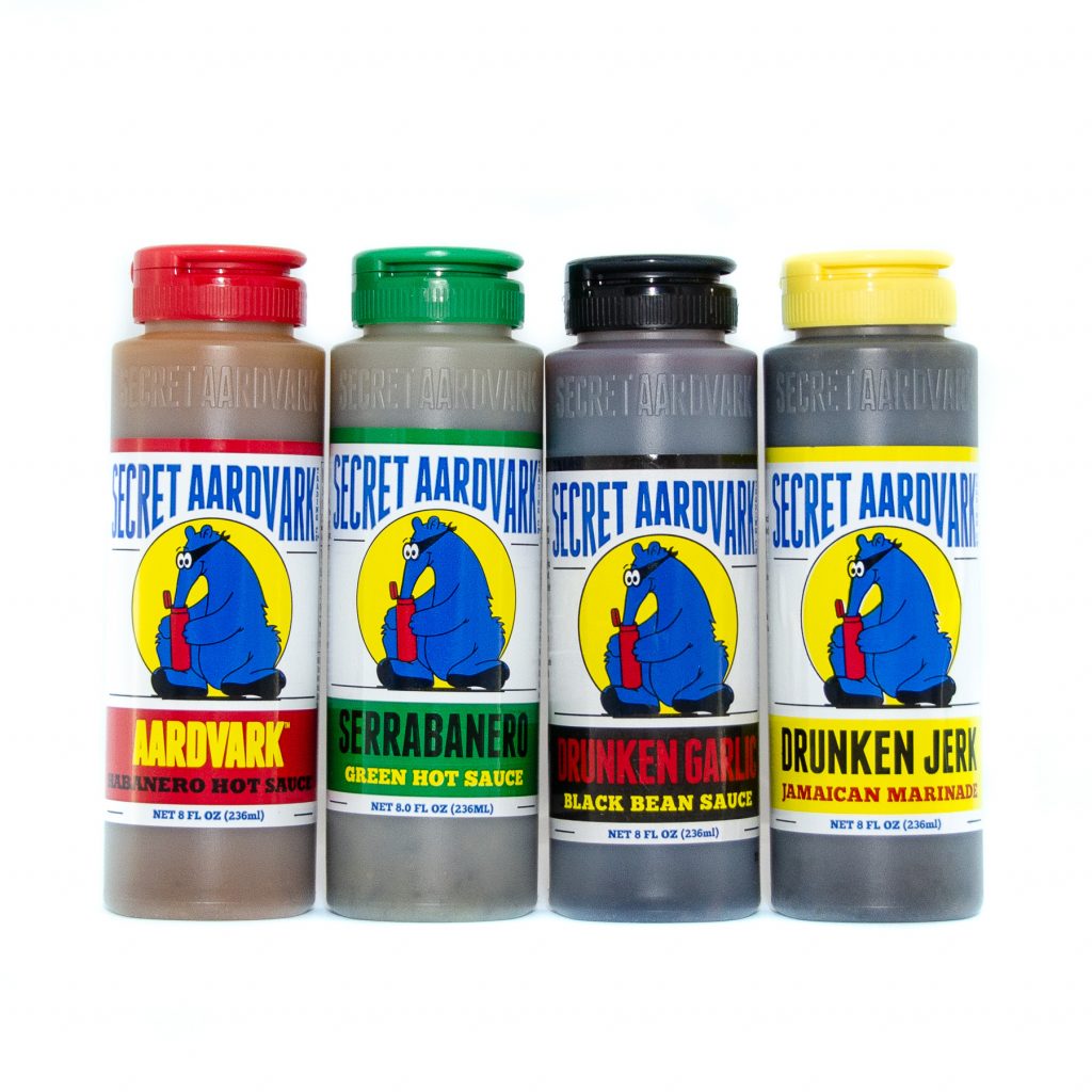 Bottles of Secret Aardvark sauces (Drunken Jerk, Aardvark Habanero, Drunken Garlic, and Serrabanero)