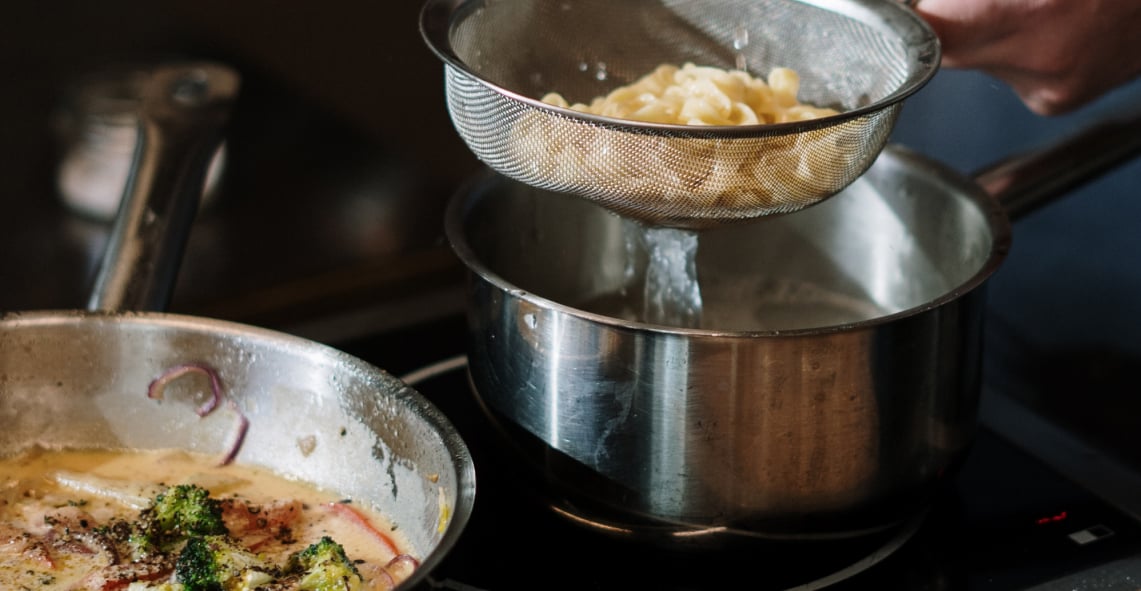 Pasta noodles and sauce being cooked