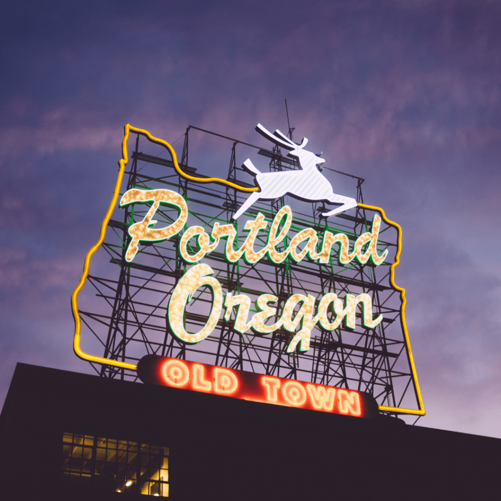 Night view of lighted Portland Oregon old town sign