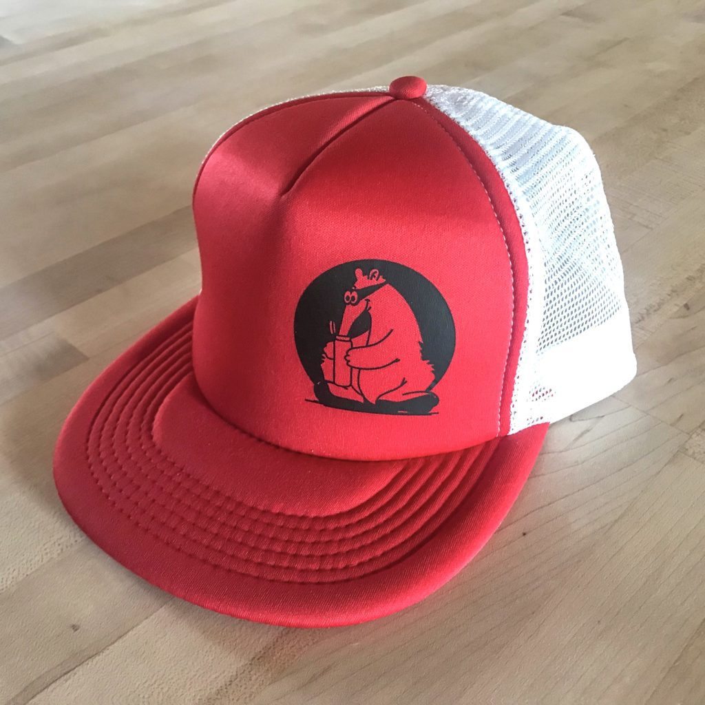 Red Secret Aardvark trucker hat with Black Secret Aardvark logo
