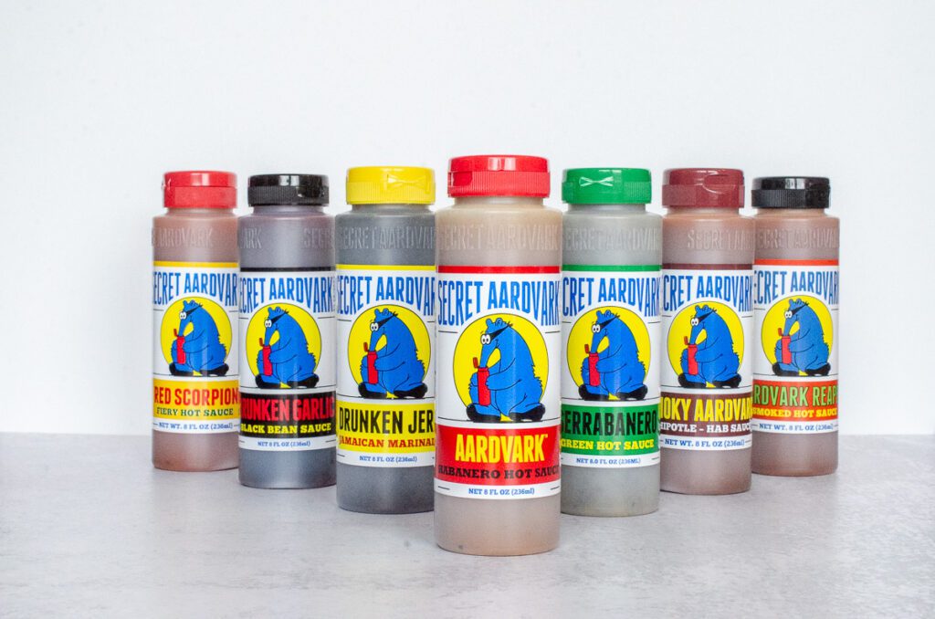 Bottles of all Seven Secret Aardvark sauces and marinades.