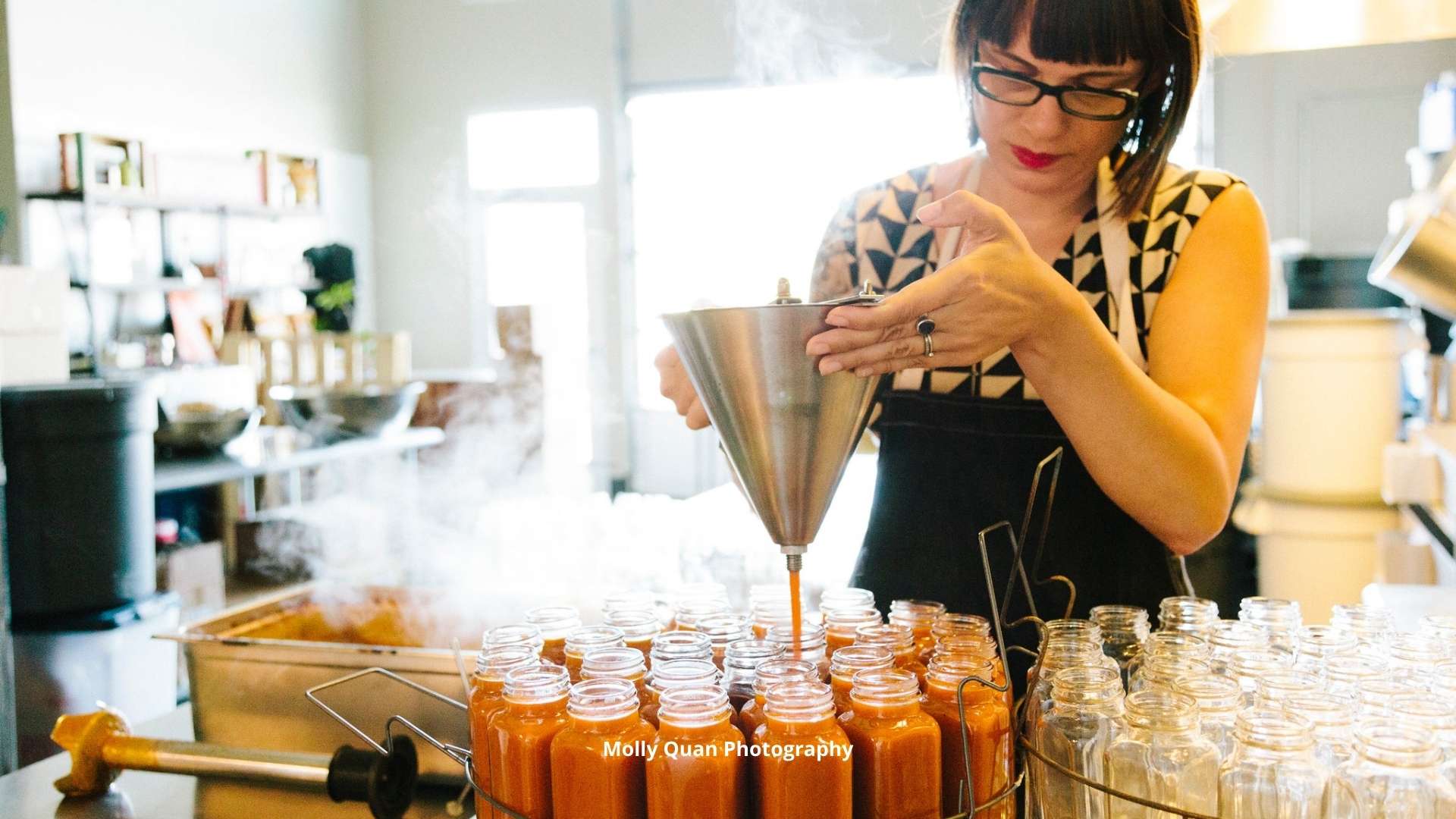 Sarah Marshall Filling Hot Sauce Bottles. Image by Molly Quan Photography.