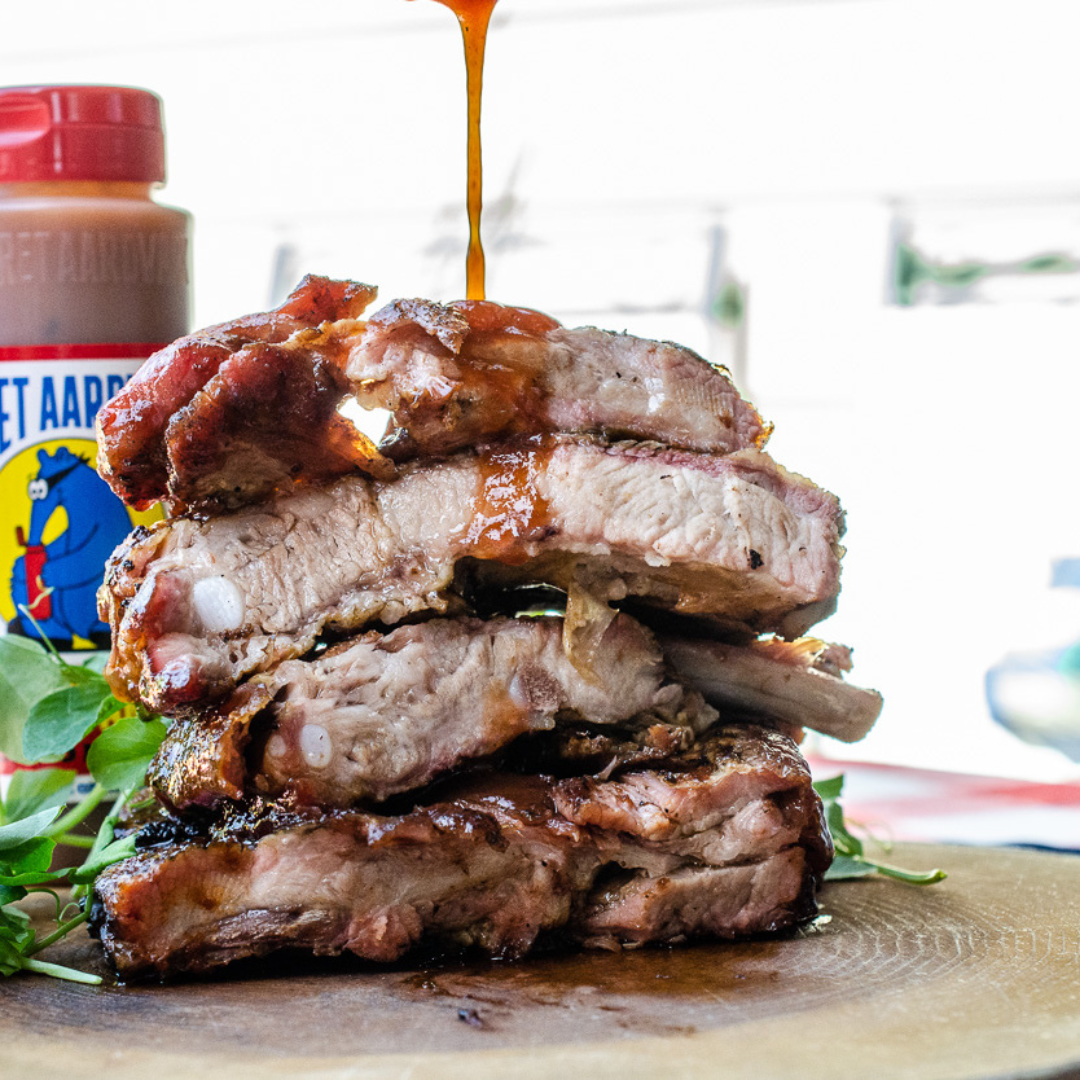 A mile-high pile of ribs drizzled in Secret Aardvark Dr. Pepper Habanero Hot Sauce