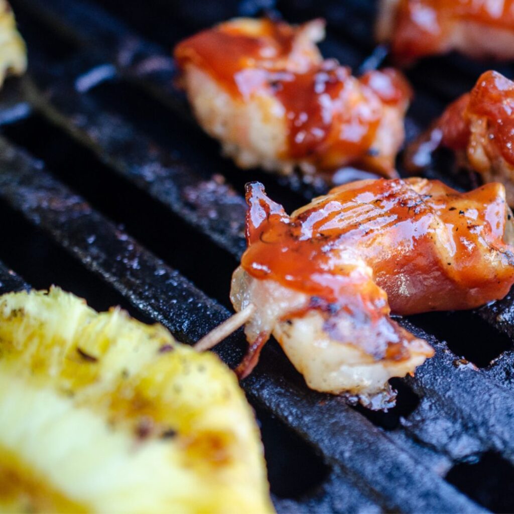 Bacon Wrapped Shrimp on a grill with Secret Aardvark Bourbon Habanero BBQ Sauce