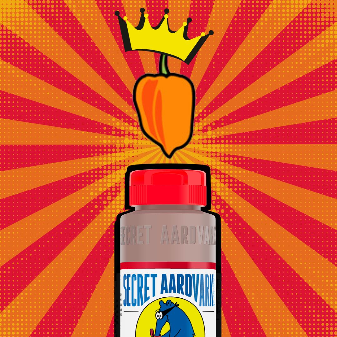 A cartoon of a pepper floating above a bottle of Secret Aardvark habanero hot sauce.