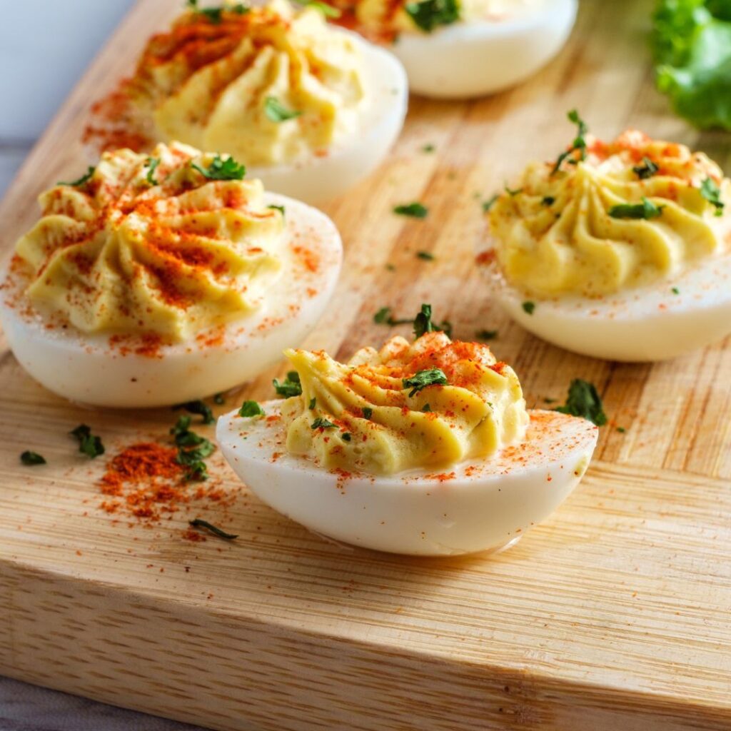 A delicious looking bunch of deviled eggs pictured on a cutting board