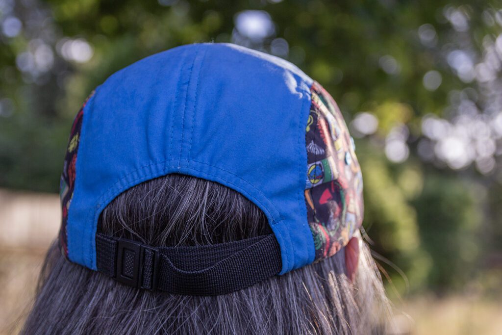 Back of side-panel camper hat on head.