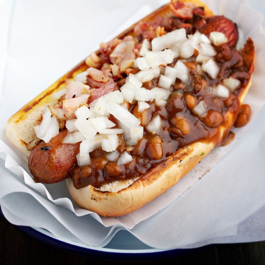 A yummy-looking chili dog that doesn't look all sweaty from sitting under a convenience store heat lamp.