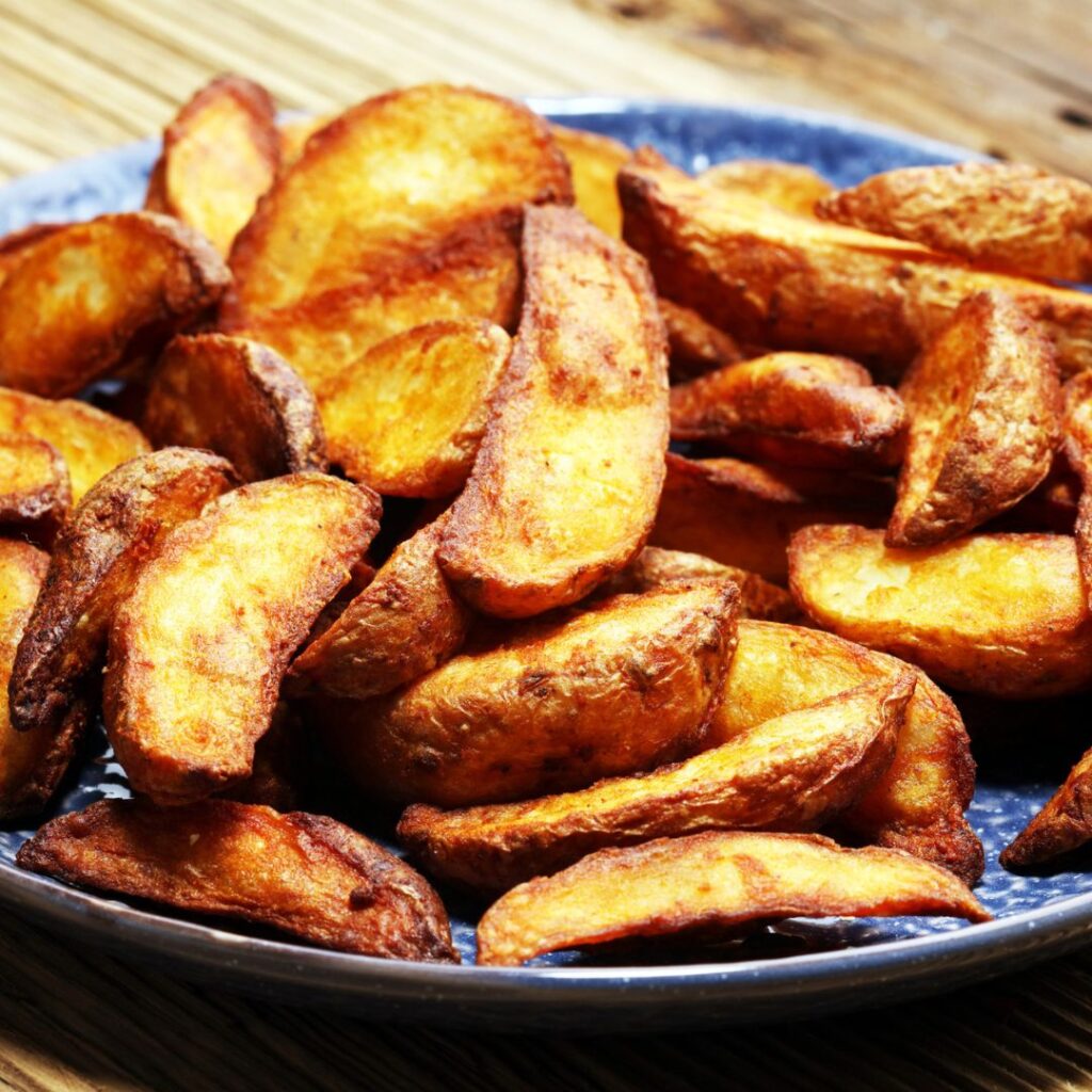 A plate of fried jo jo potatoes, ready for a splash of hot sauce.