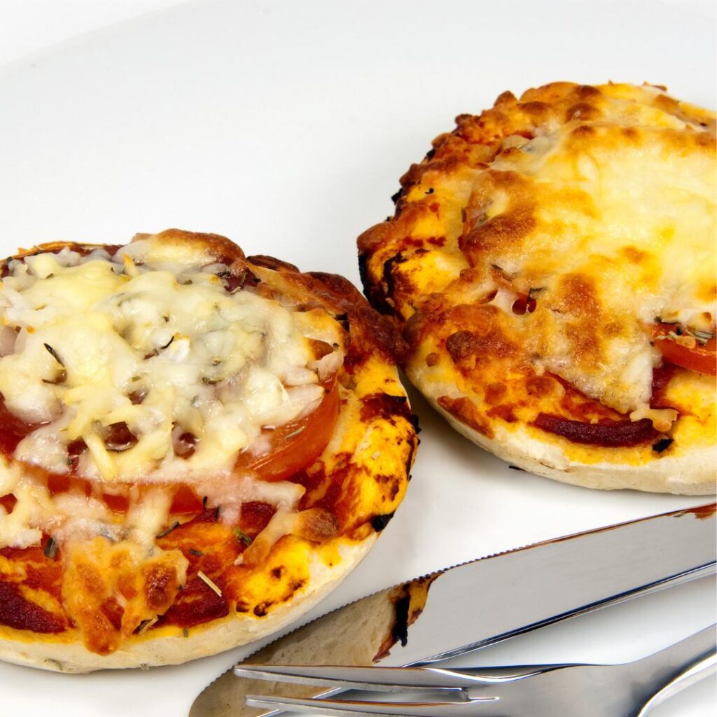 Two spicy little mini pizzas on English muffin bread, all hot an toasty from the toaster oven.