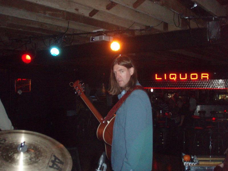 Scott Moritz, founder of Secret Aardvark, standing on stage with his band The Slow Drags.